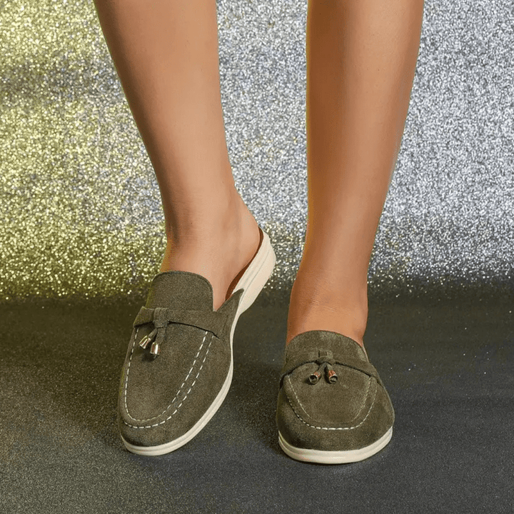 Close view foot wearing green slip-on everyday casual shoes