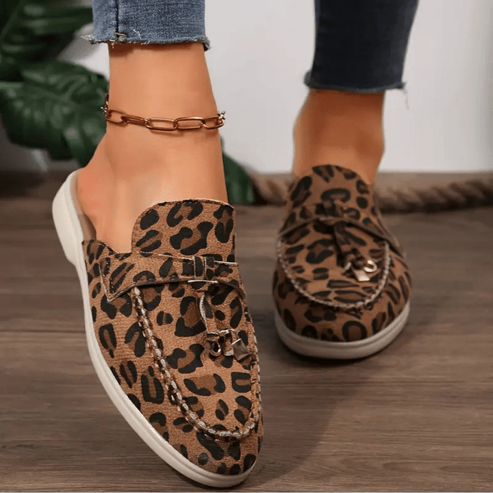 Foot model showing loafers front view angle simple plain background