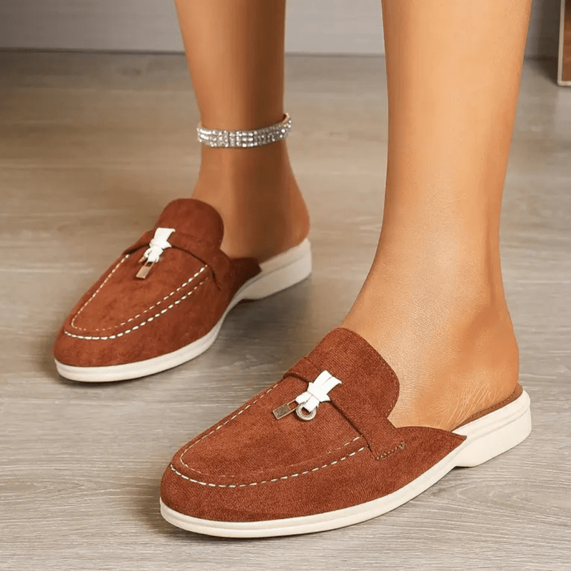 Side view foot wearing slip-on moccasins plain background minimal style