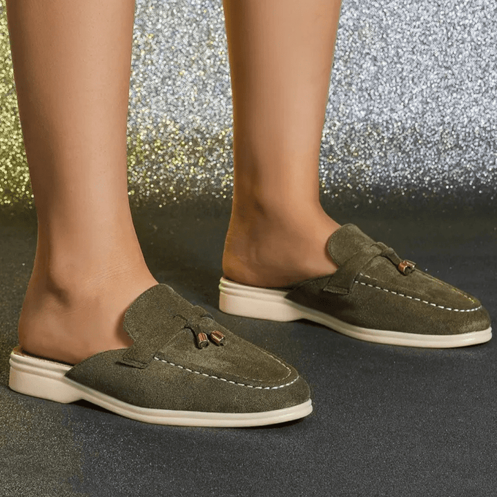Side angle foot model wearing green casual slip-on shoes