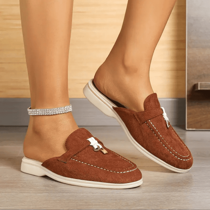 Front view foot wearing slip-on shoe plain background isolated style