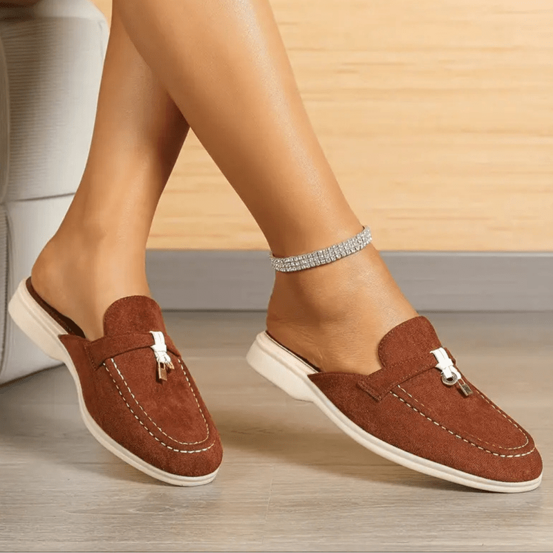 Close-up foot wearing casual moccasins plain background simple presentation style