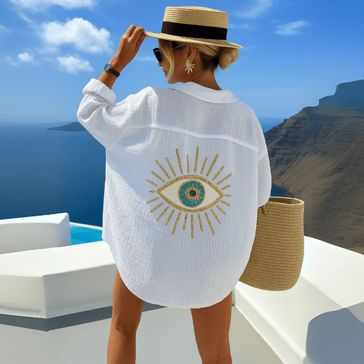 Woman wearing lightweight bohemian cotton shirt back view on nature background.