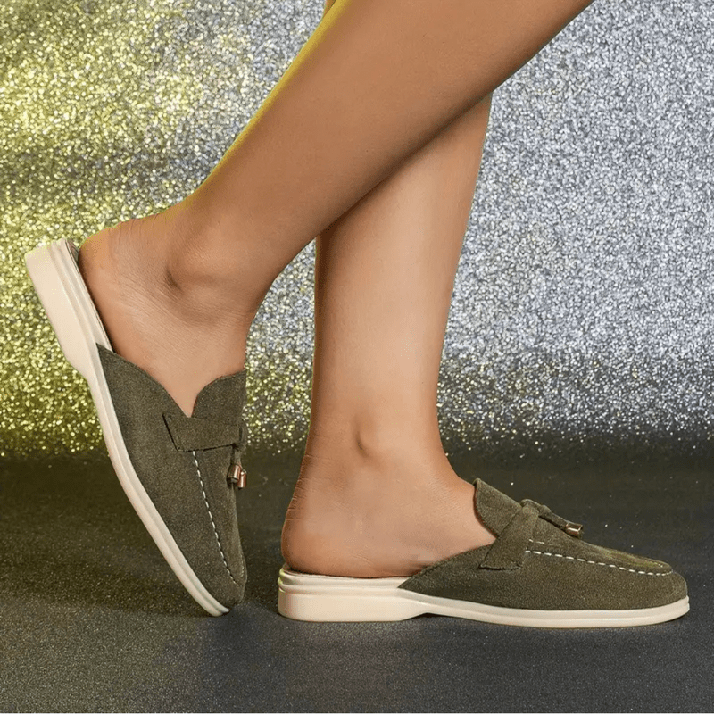 Side profile green flat shoes worn by foot plain background