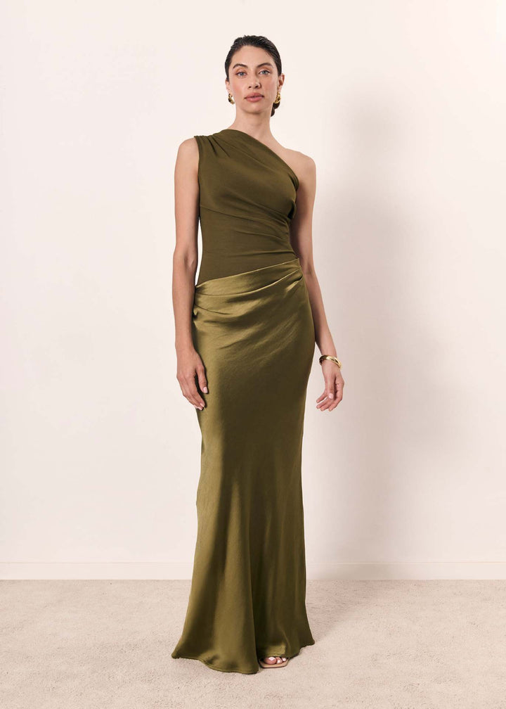 Female model in a sophisticated evening dress featuring an asymmetrical neckline.

F