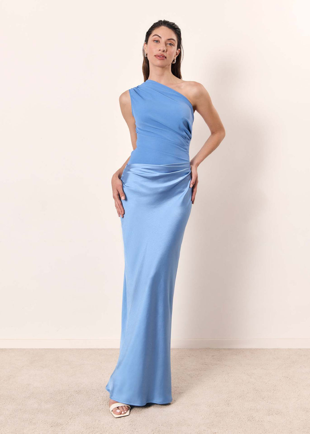 Woman styled in a one-shoulder formal dress suitable for weddings and celebrations.