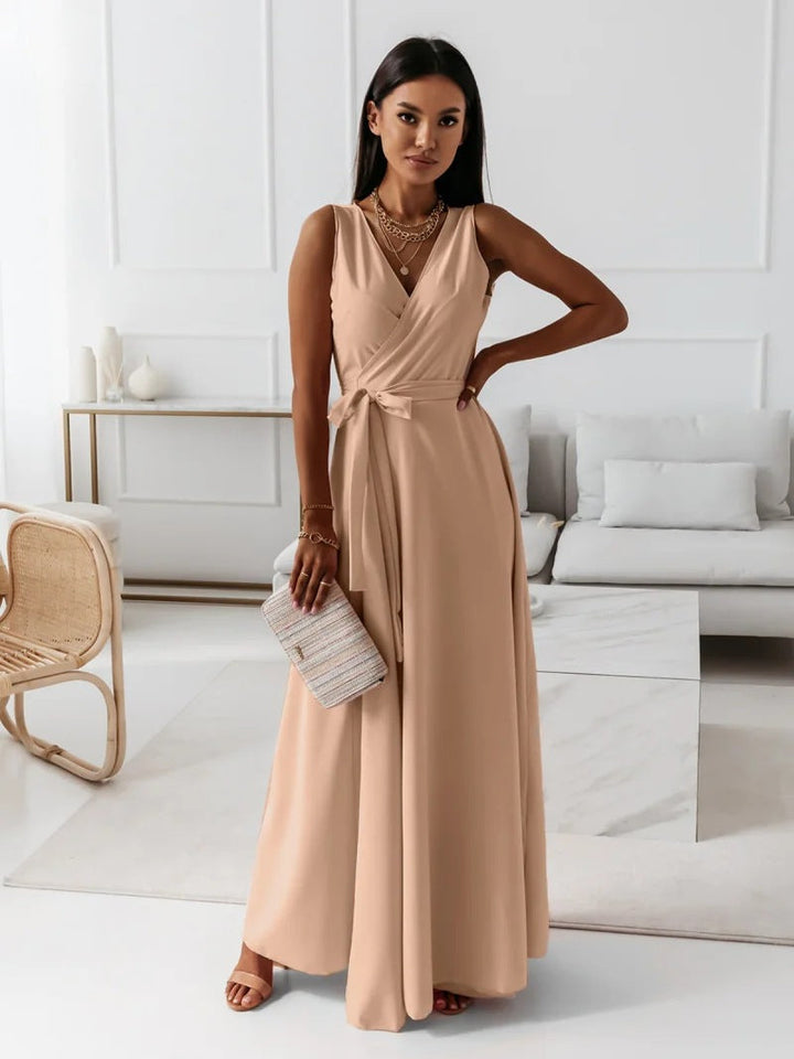 Woman posing in wrap dress with soft drape, living room.