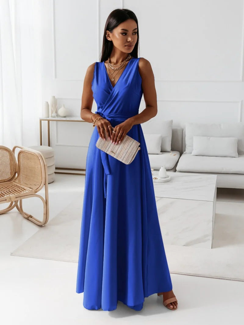 Woman in elegant summer dress posing gracefully inside living room.