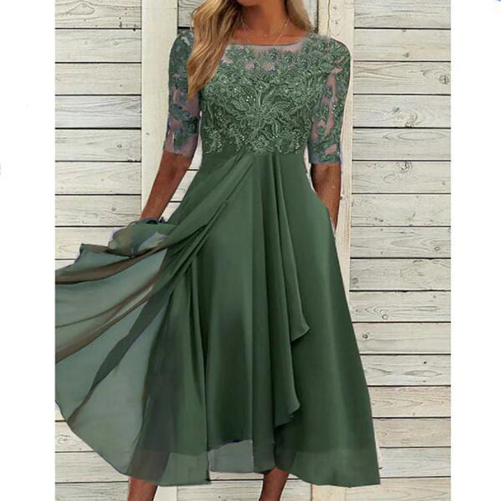 Female model presenting a romantic formal dress with elegant lace styling on a plain background.