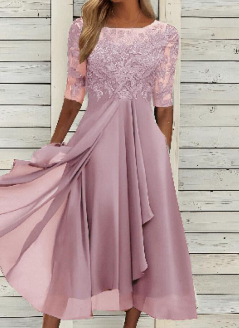Female model showcasing a sleeveless evening gown with elegant lace accents on a plain background.