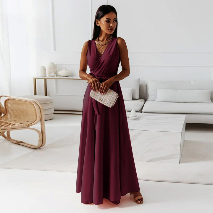 Woman showing side angle of elegant maxi dress in living room.