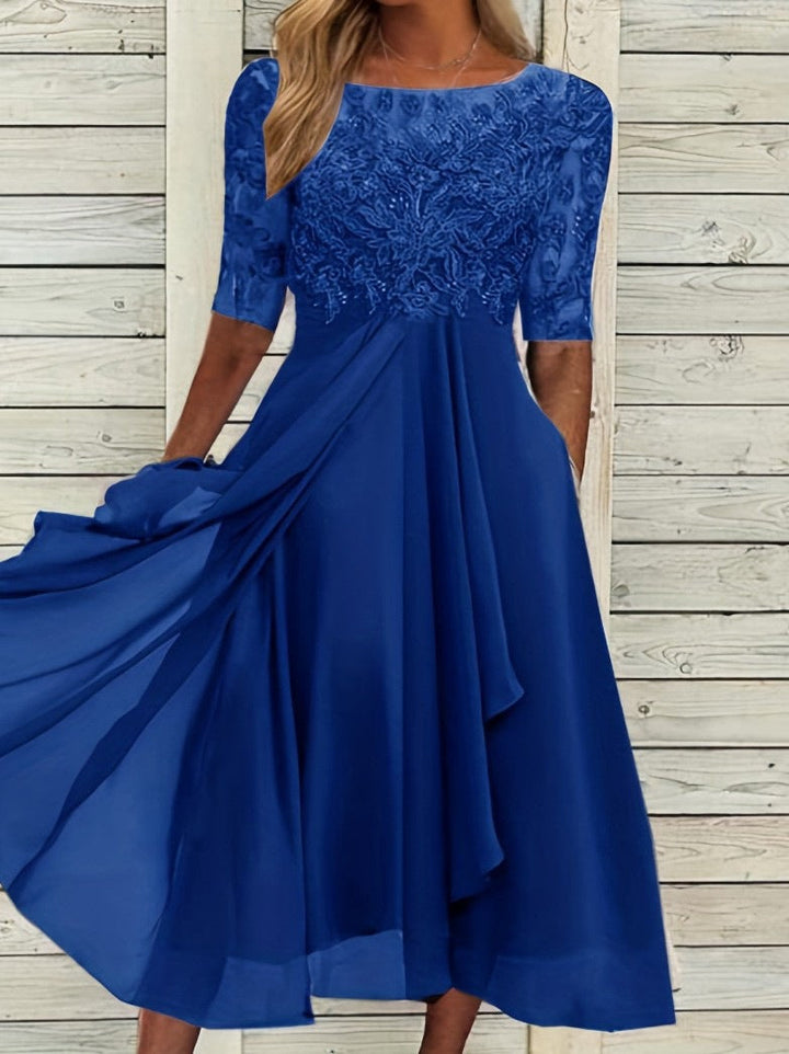 Female model in a stylish ankle-length dress designed for evening events on a plain background.