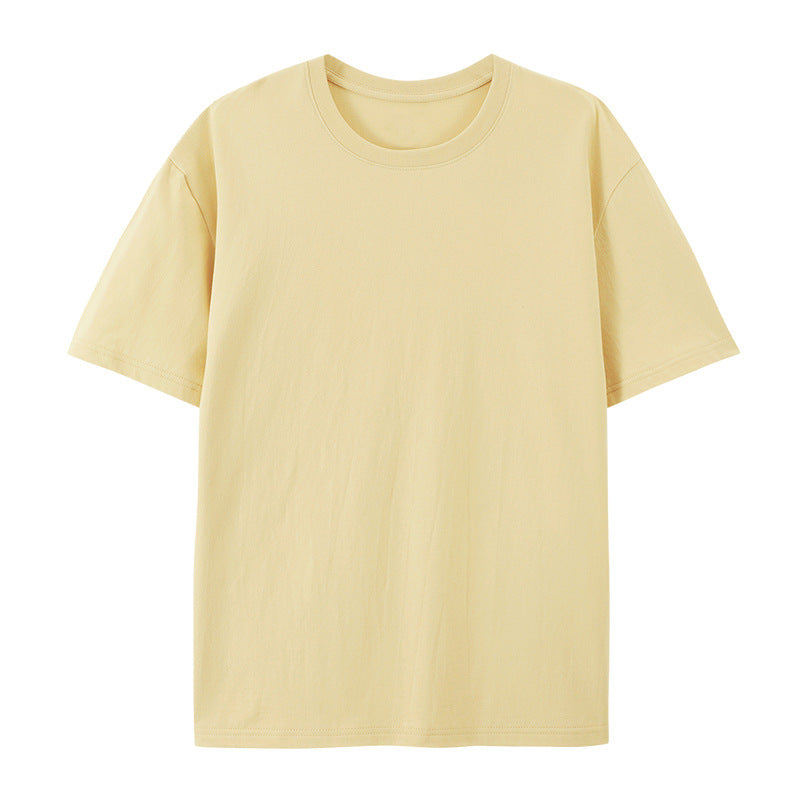 Woman in a lightweight cotton T-shirt with an oversized shape against a plain background.
