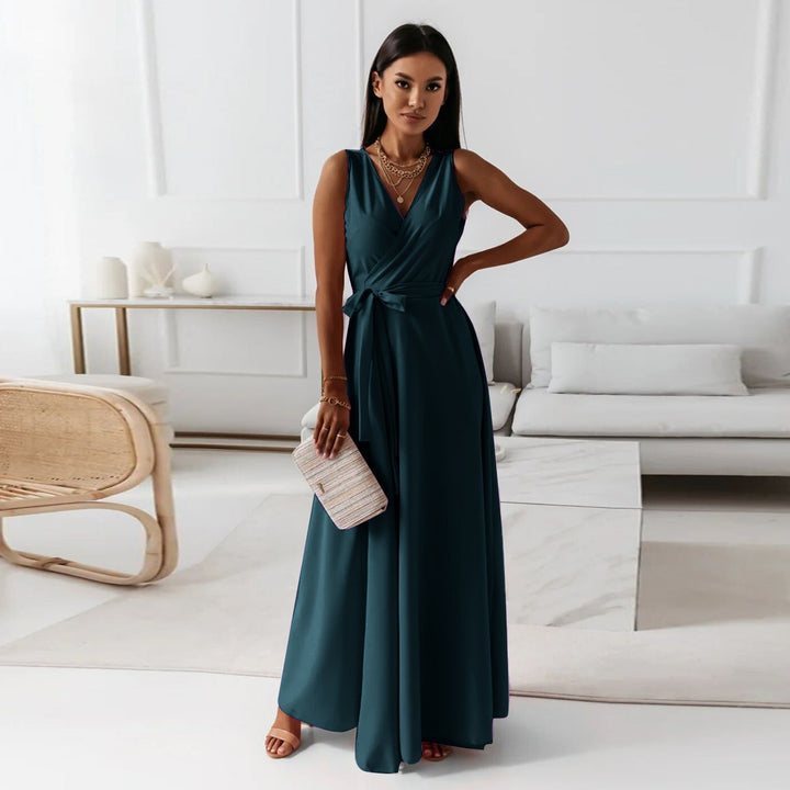 Female model in wrap maxi dress posing indoors, living room.