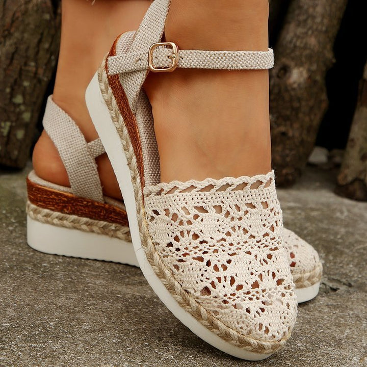 Front view of espadrilles worn on foot against plain background