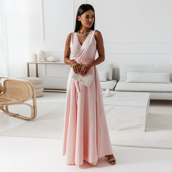 Woman wearing elegant flowing maxi dress in living room, front view.