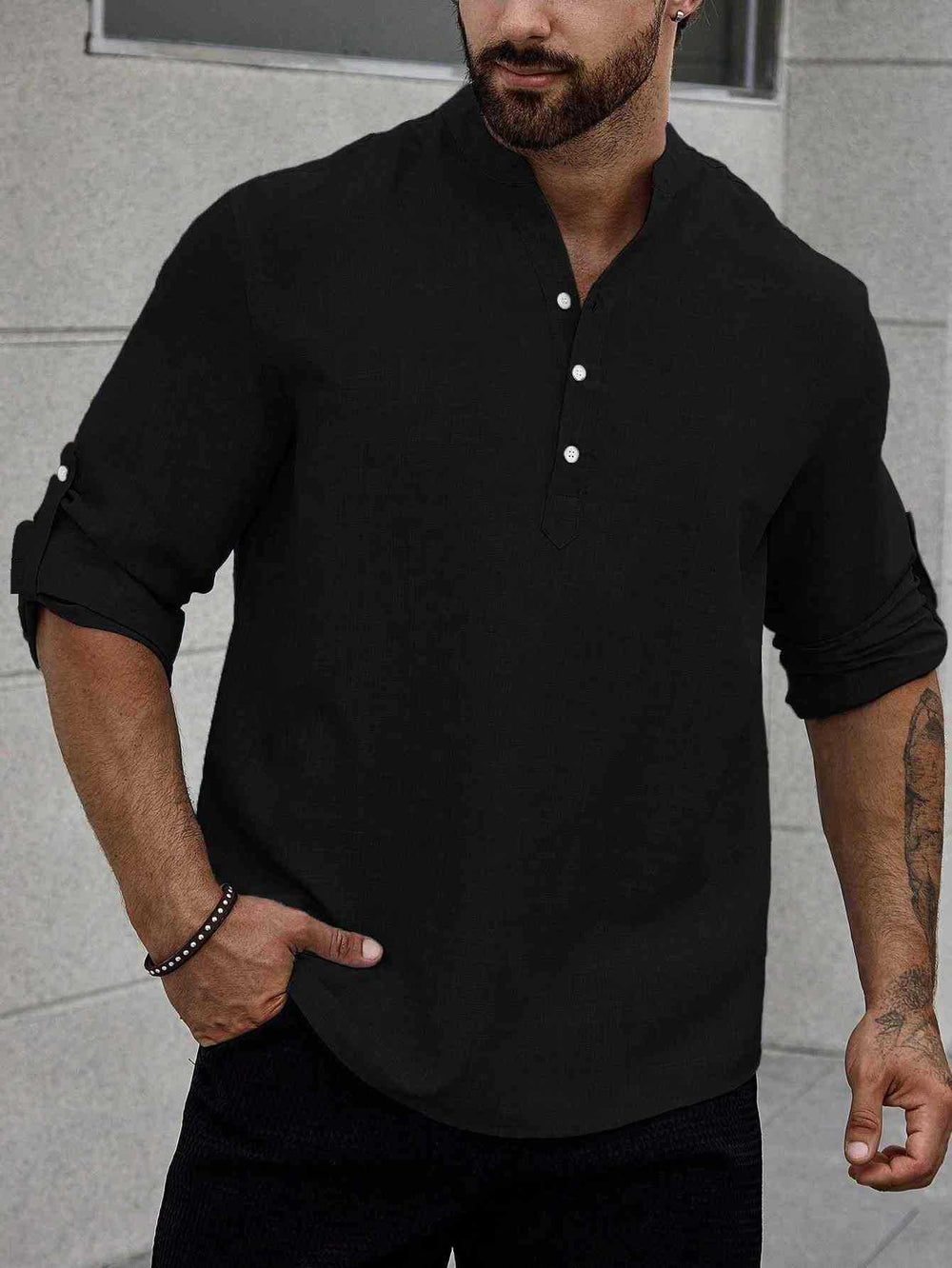 Man showcasing a long-sleeve casual shirt with a tailored fit on a plain background.
