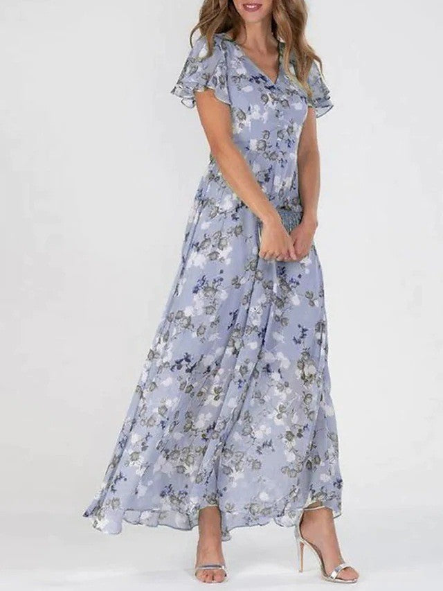 Female model standing in a midi dress against a plain backdrop.
