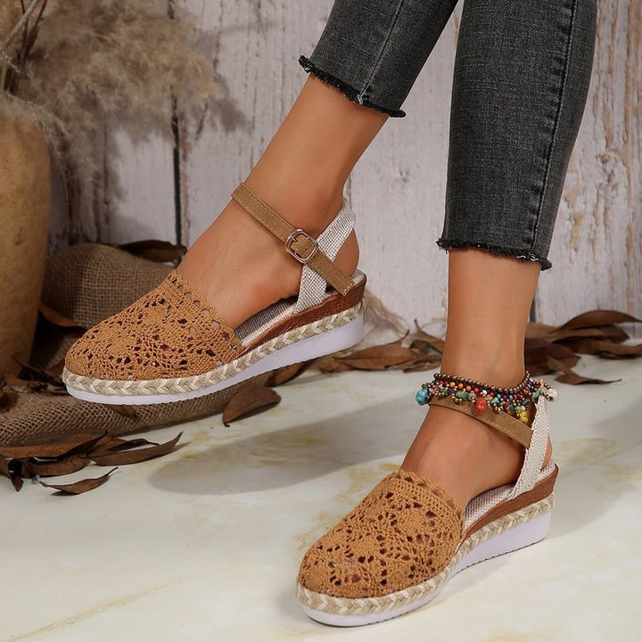 Pair of espadrilles top view on plain background with foot