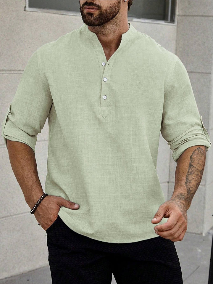 Male model wearing a versatile button-up shirt against a plain backdrop.
