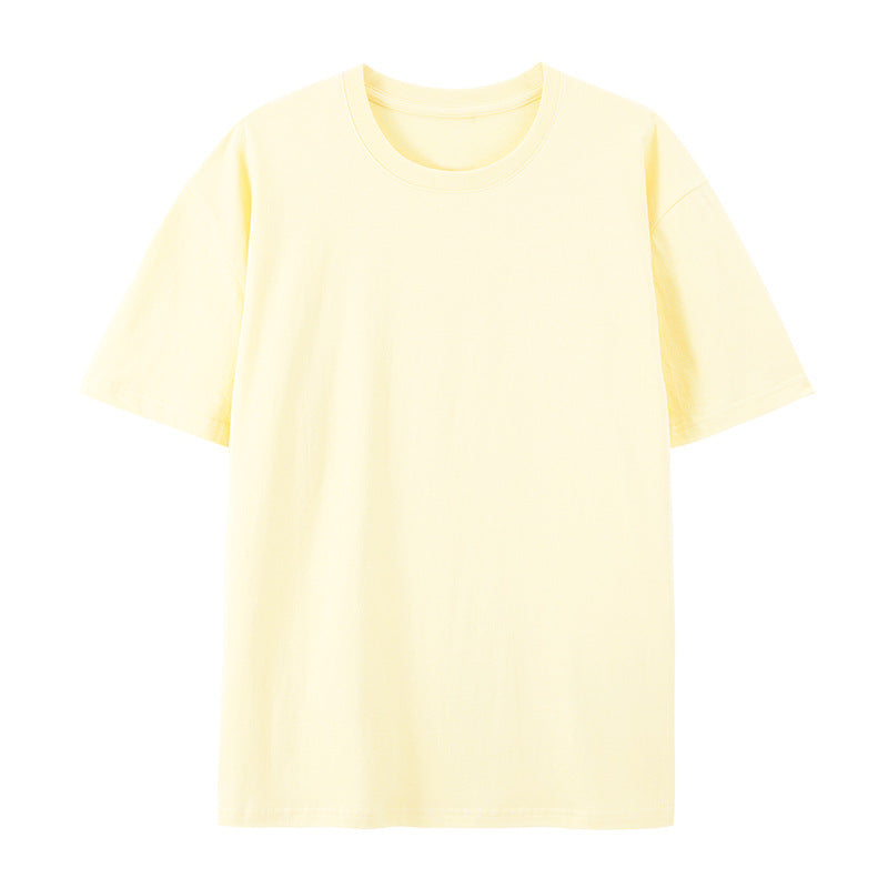 Woman showcasing a loose-fit short-sleeve cotton T-shirt on a plain backdrop.
