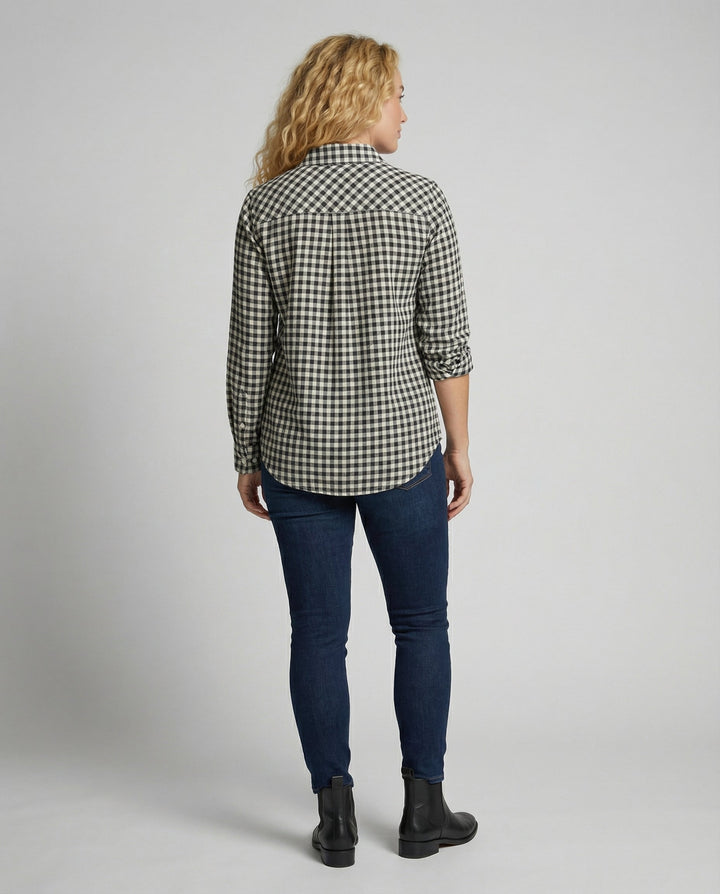 Female model wearing a long-sleeve checked blouse with an oversized fit.
