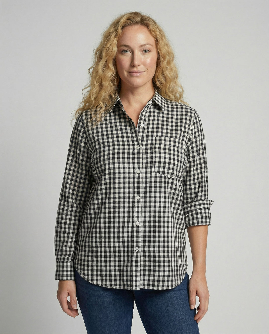 Female model wearing an oversized checked shirt blouse with long sleeves against a plain background.