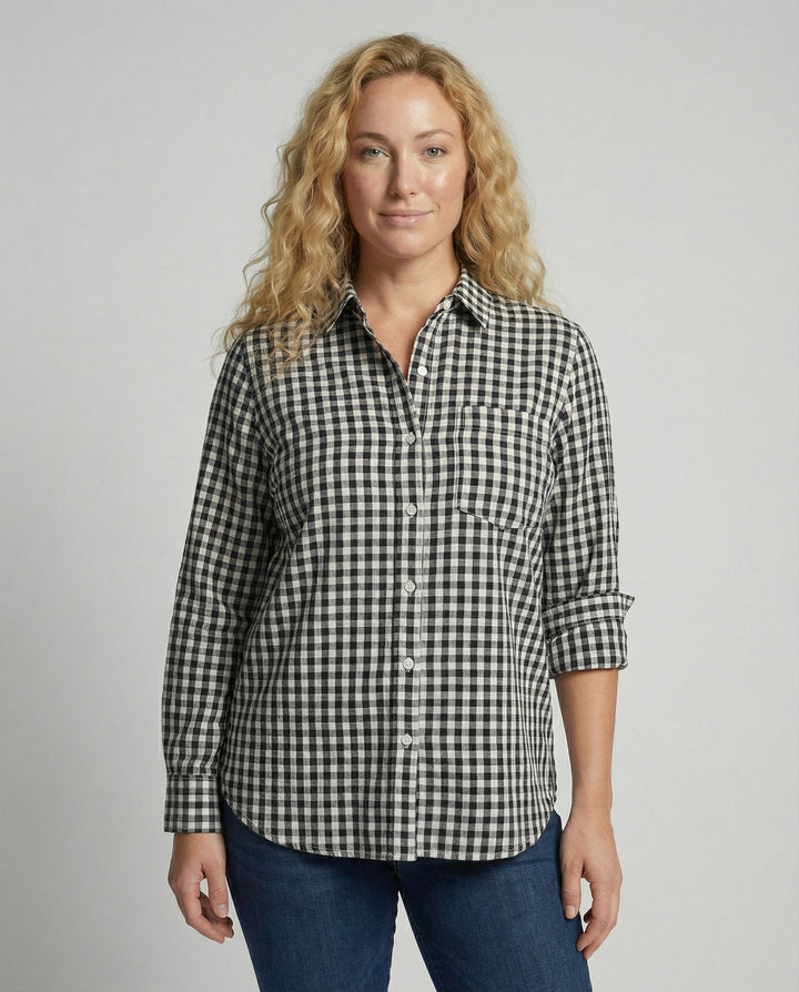 Female model wearing an oversized checked shirt blouse with long sleeves against a plain background.
