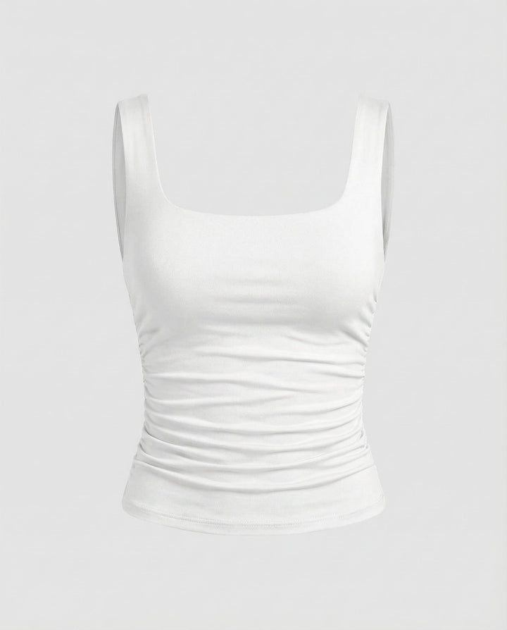 Woman in a fitted stretch top with broad straps and a sleek shape.