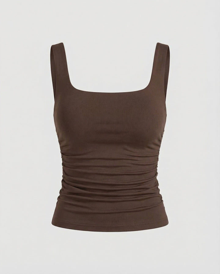 Woman wearing a sleeveless fitted top with a clean and modern silhouette.