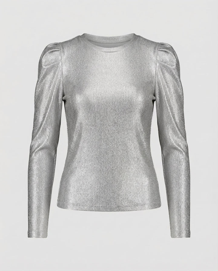 Female model in a shimmering blouse styled with dramatic puff sleeves.
