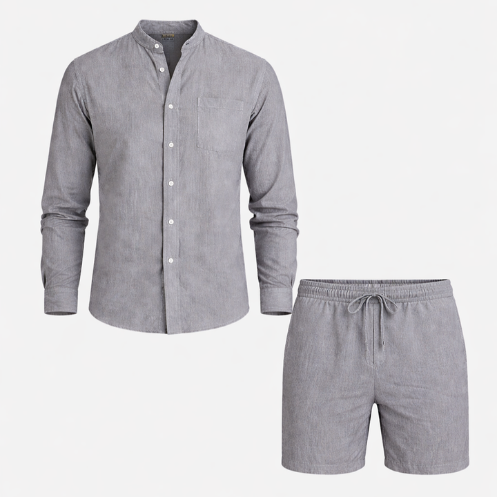  Male model posing in a relaxed button shirt and drawstring pants on a plain background.