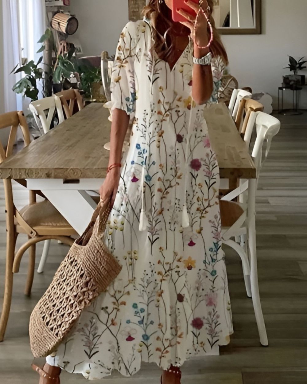Woman wearing a loose-fit patterned dress with carefree styling on a plain background.