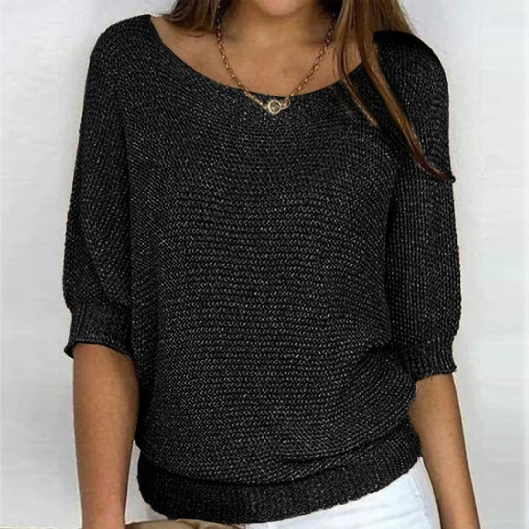 Woman showing batwing sleeve detail front plain background clean look