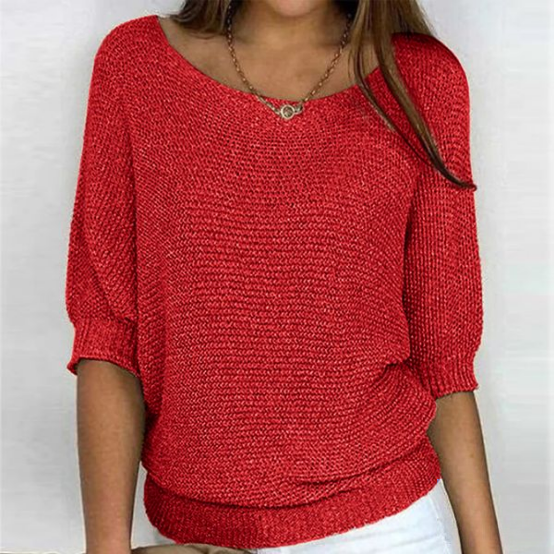 Woman showcasing boat neck sweater close front plain background