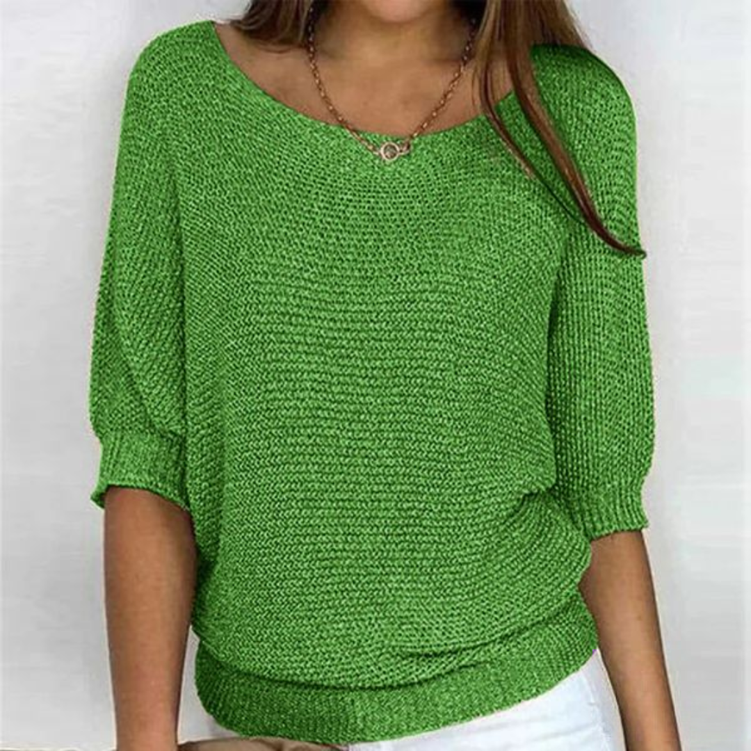 Woman wearing loose knit sweater front view plain background minimal
