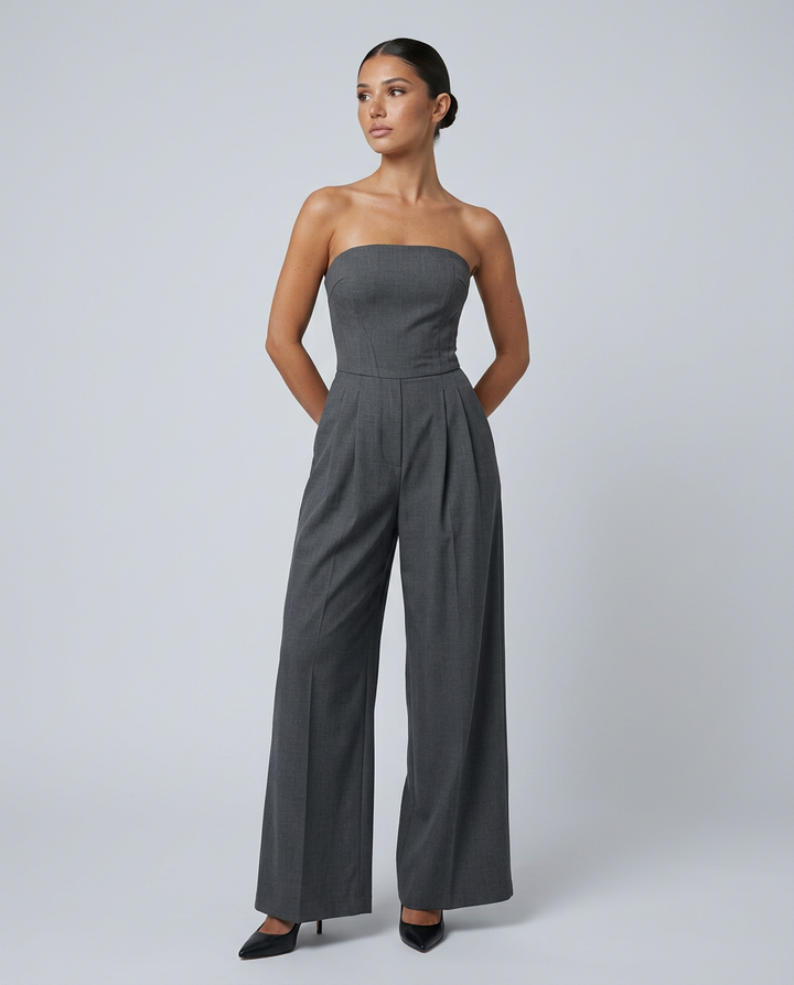 Model in a summer event jumpsuit against a plain background.