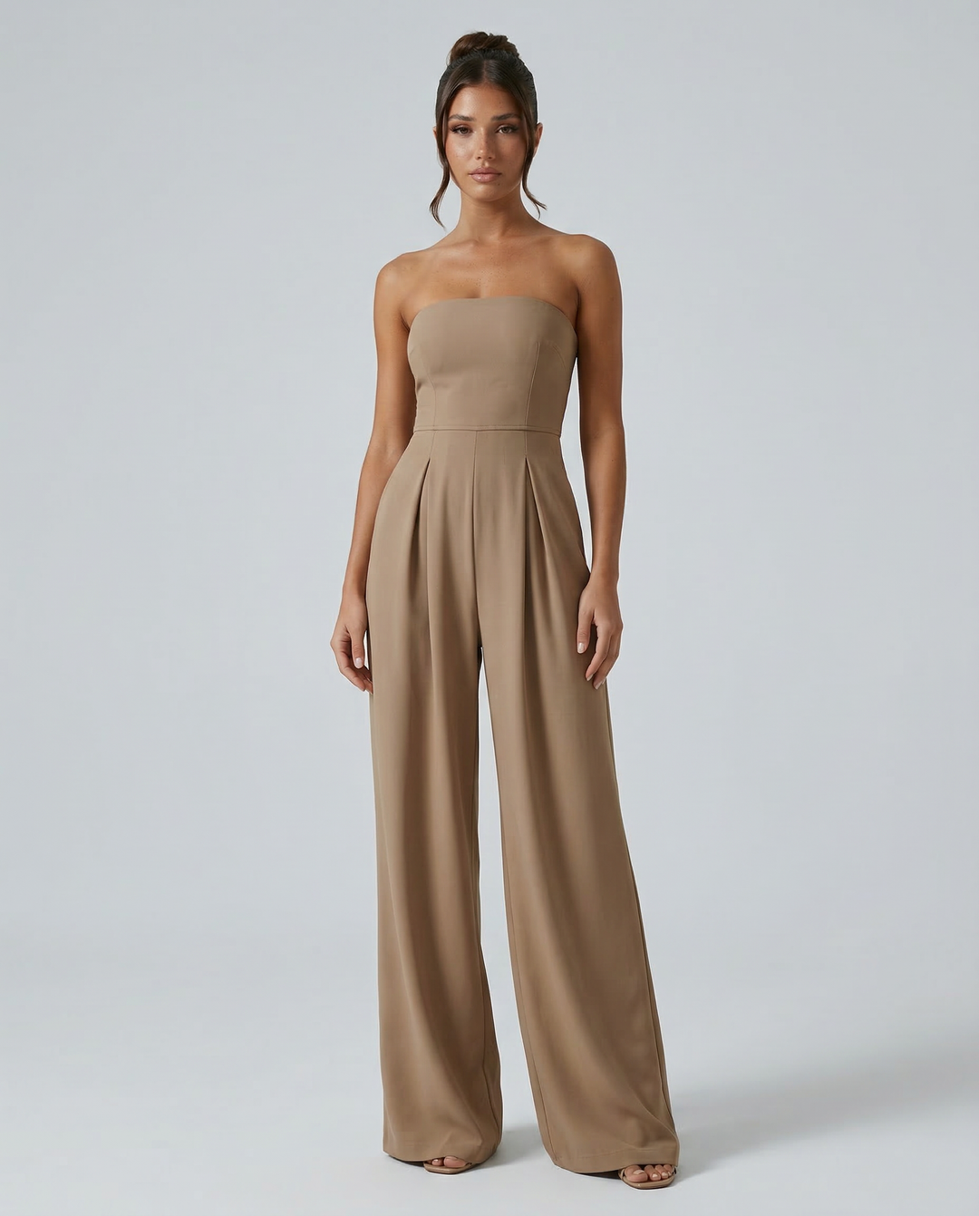 Model in a clean wide-leg jumpsuit silhouette against a plain background.