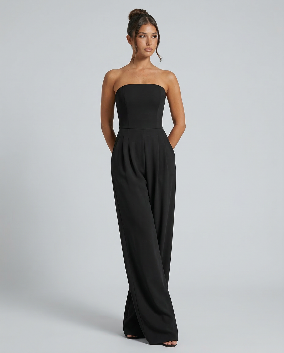 Model wearing a relaxed wide-leg jumpsuit on a plain background.