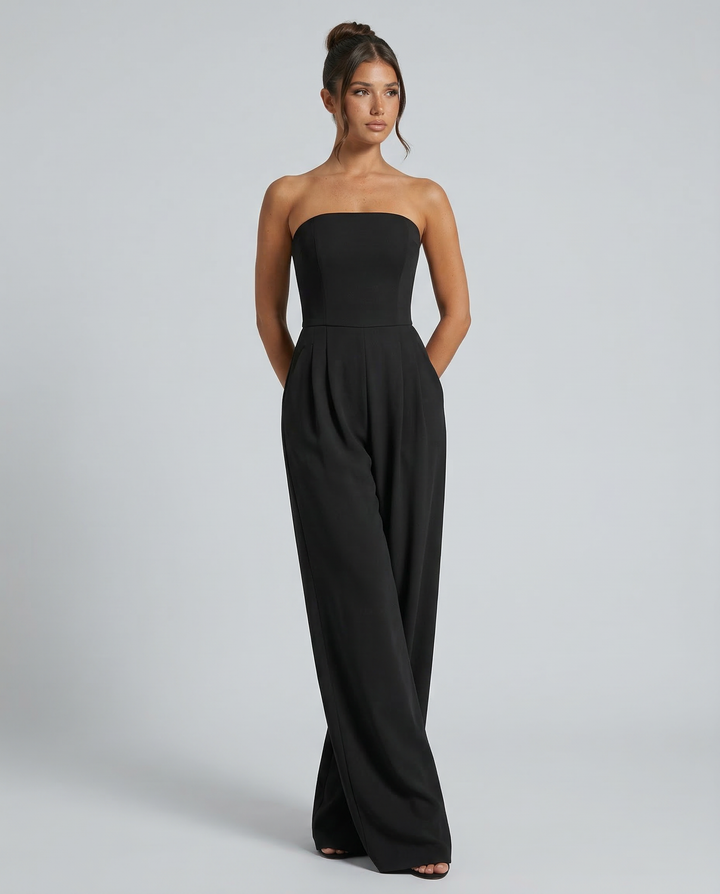 Model wearing a relaxed wide-leg jumpsuit on a plain background.