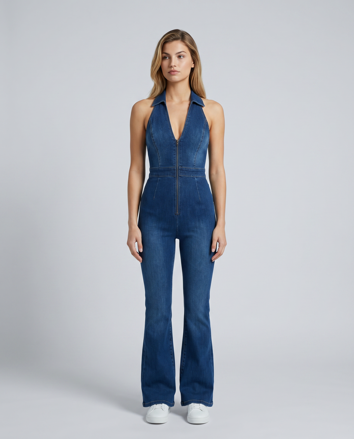 Female model wearing a blue flare leg denim jumpsuit on a plain background.