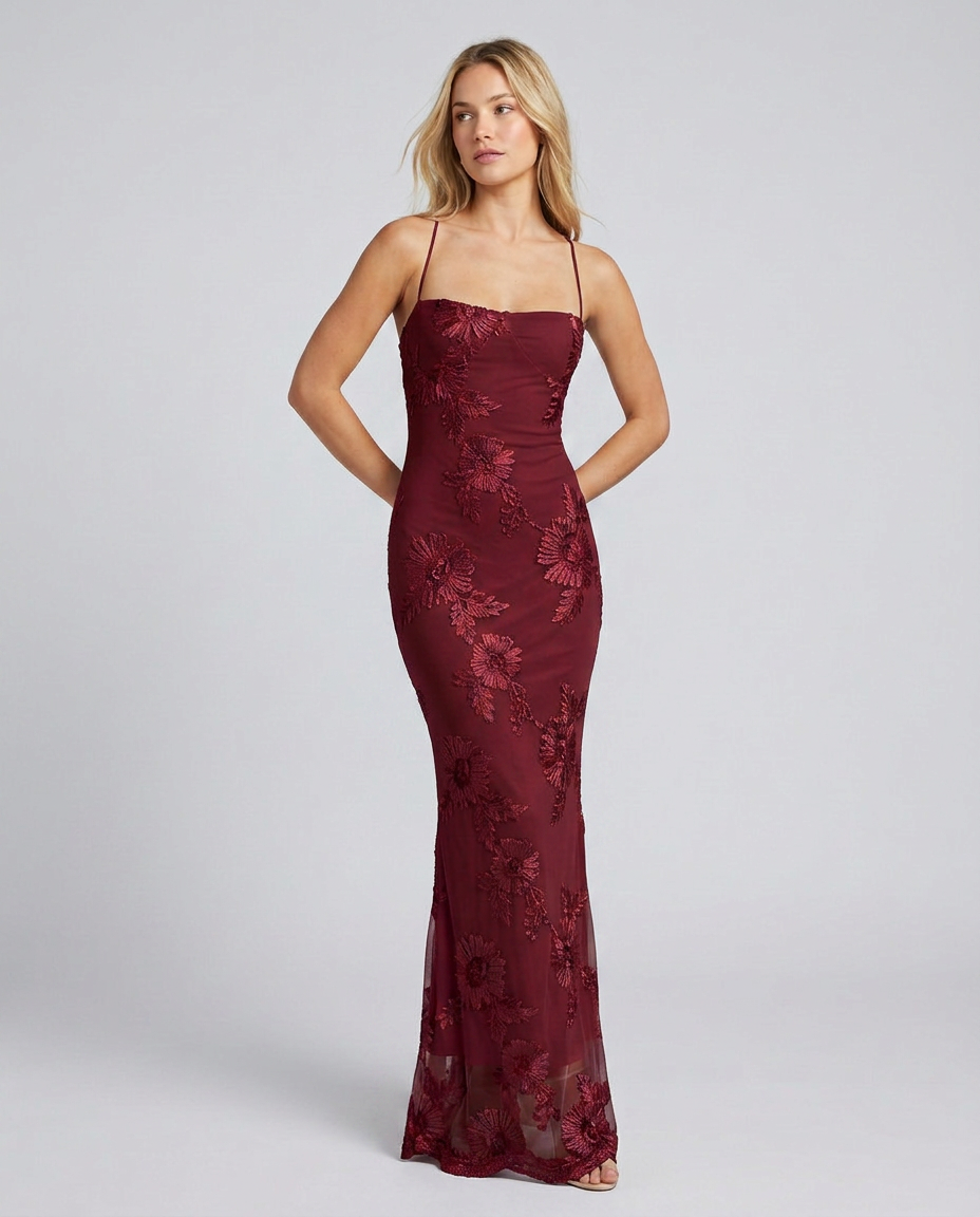 Woman showcasing a floral appliqué dress designed for weddings and evening events.