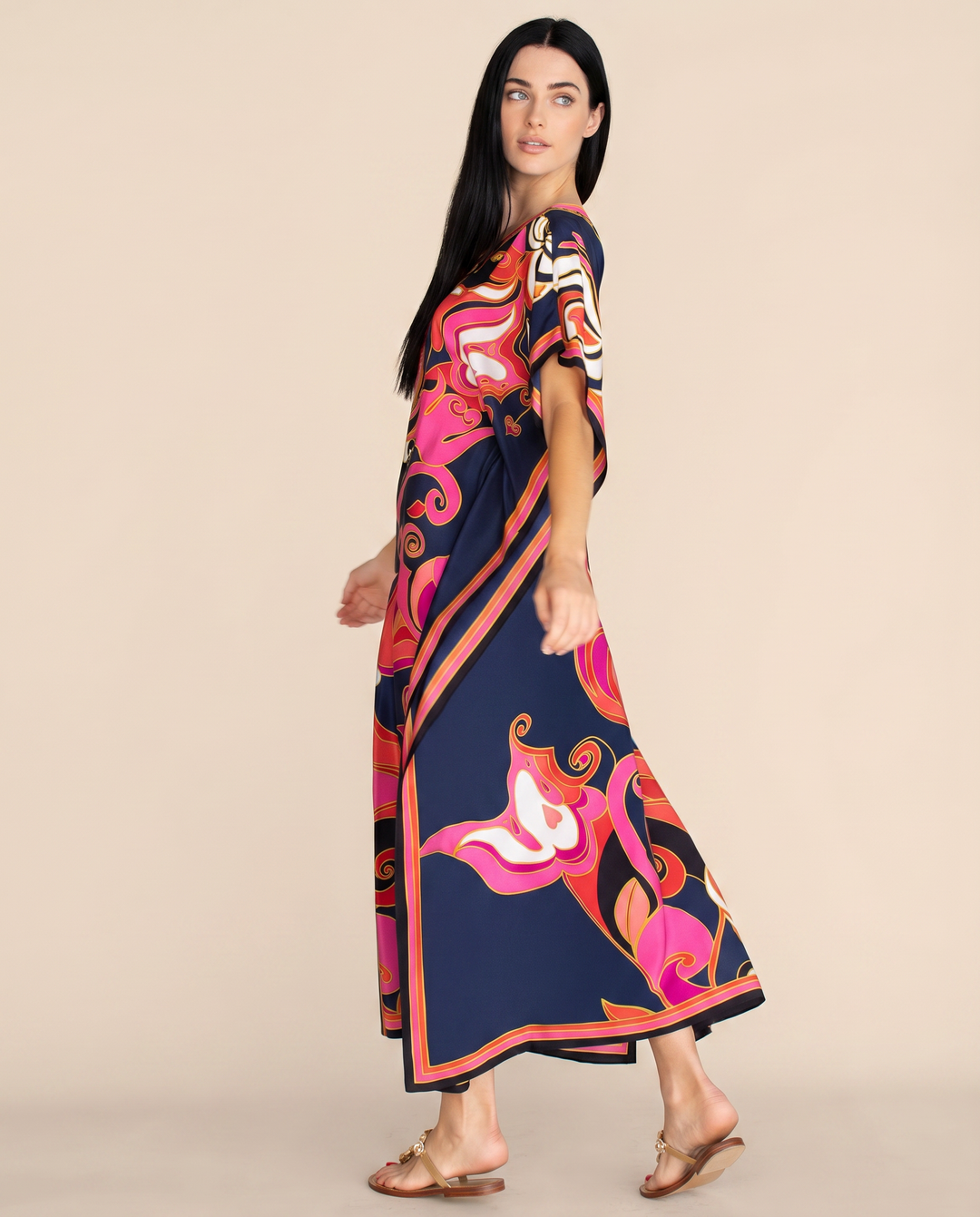 Flowy beach-ready kaftan dress with bold print displayed on a wearer against a plain background.