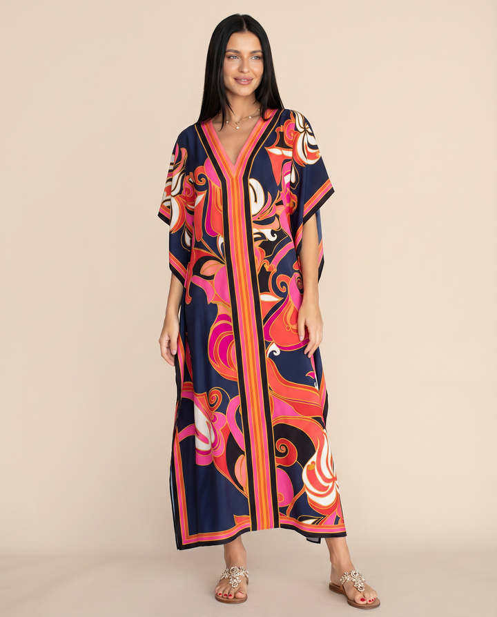 Loose flowy multicolour resort kaftan dress shown on a wearer against a plain background.