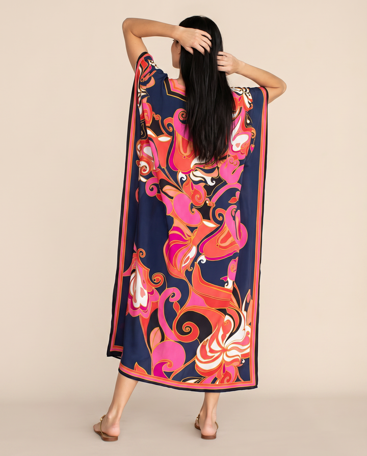 Airy multicolour summer kaftan dress with wide sleeves on a clean background, back view