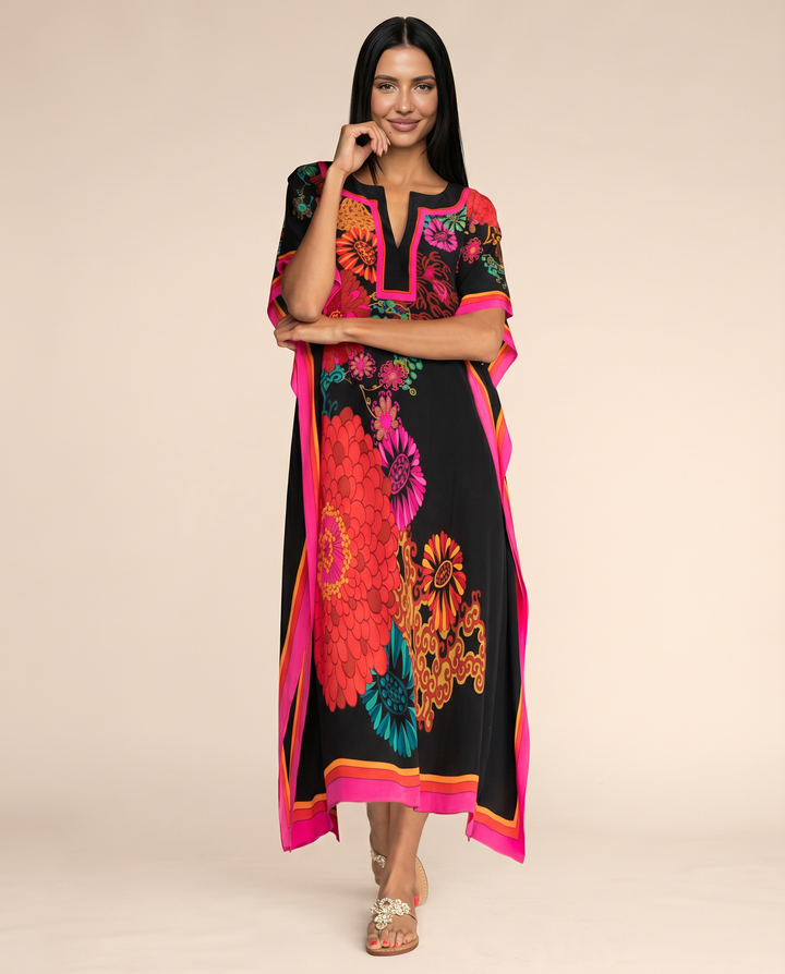 Bold multicolour holiday kaftan dress with wide sleeves on a clean background.