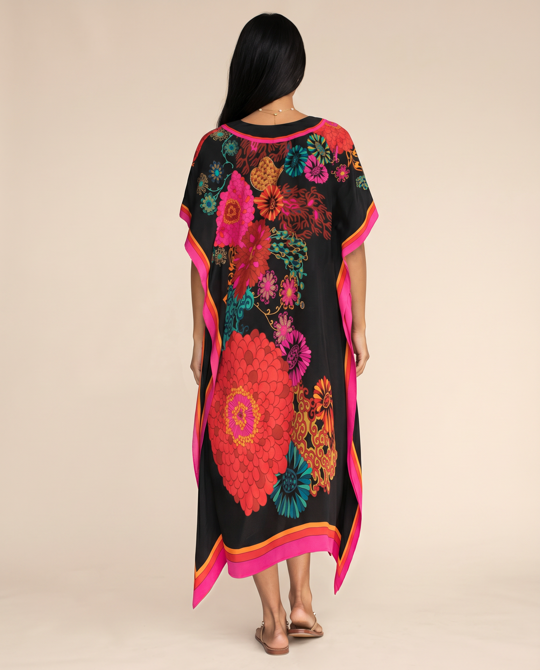 Elegant warm-weather kaftan dress with relaxed drape on a wearer against a plain background, back view