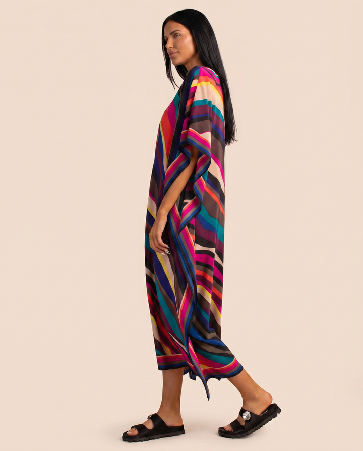 Loose multicolour resort wear dress with side slit detail on a plain background.