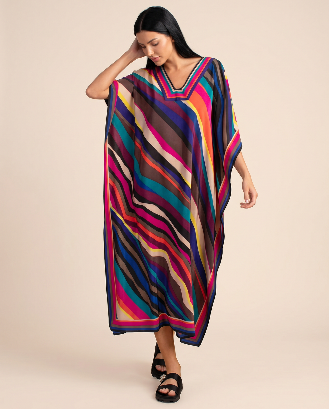 Flowy vacation kaftan dress with bold print shown on a clean background.