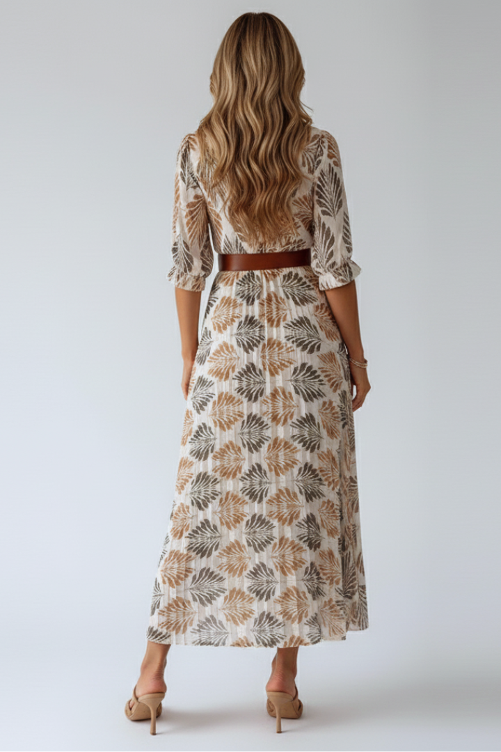 Female model in elbow-sleeve maxi dress back angle, gray background.
